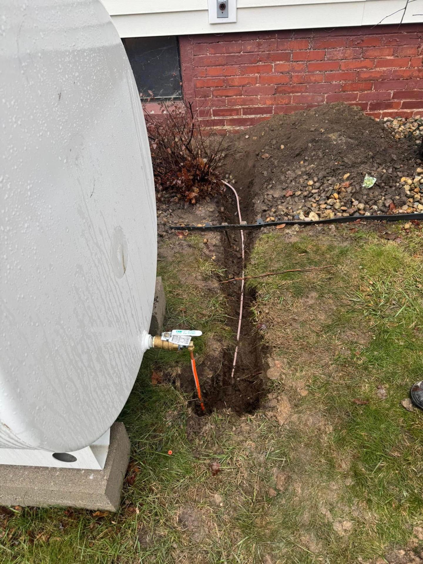 Trenched gas line run from a propane tank to a home during an HVAC fuel line installation