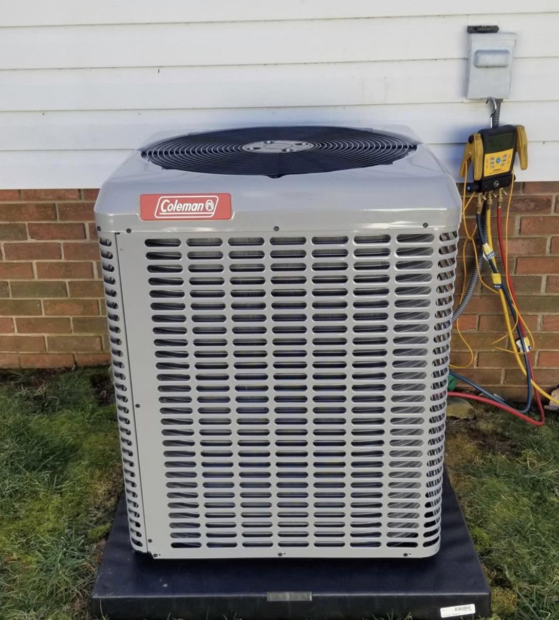Newly installed Coleman air conditioner condenser on a pad outside a Montgomery County, Indiana home