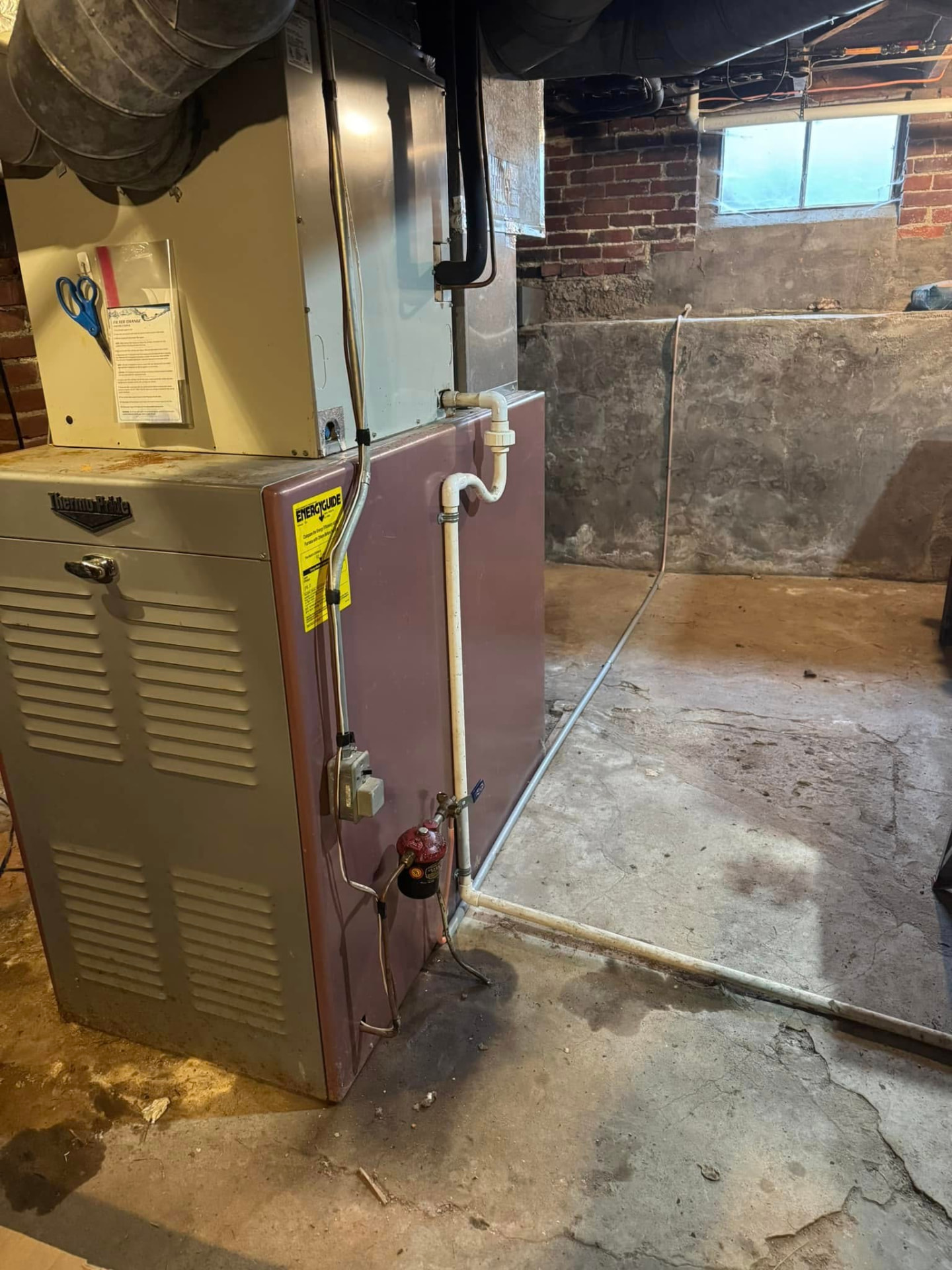 Older basement furnace and air handler evaluated for replacement in a Crawfordsville home
